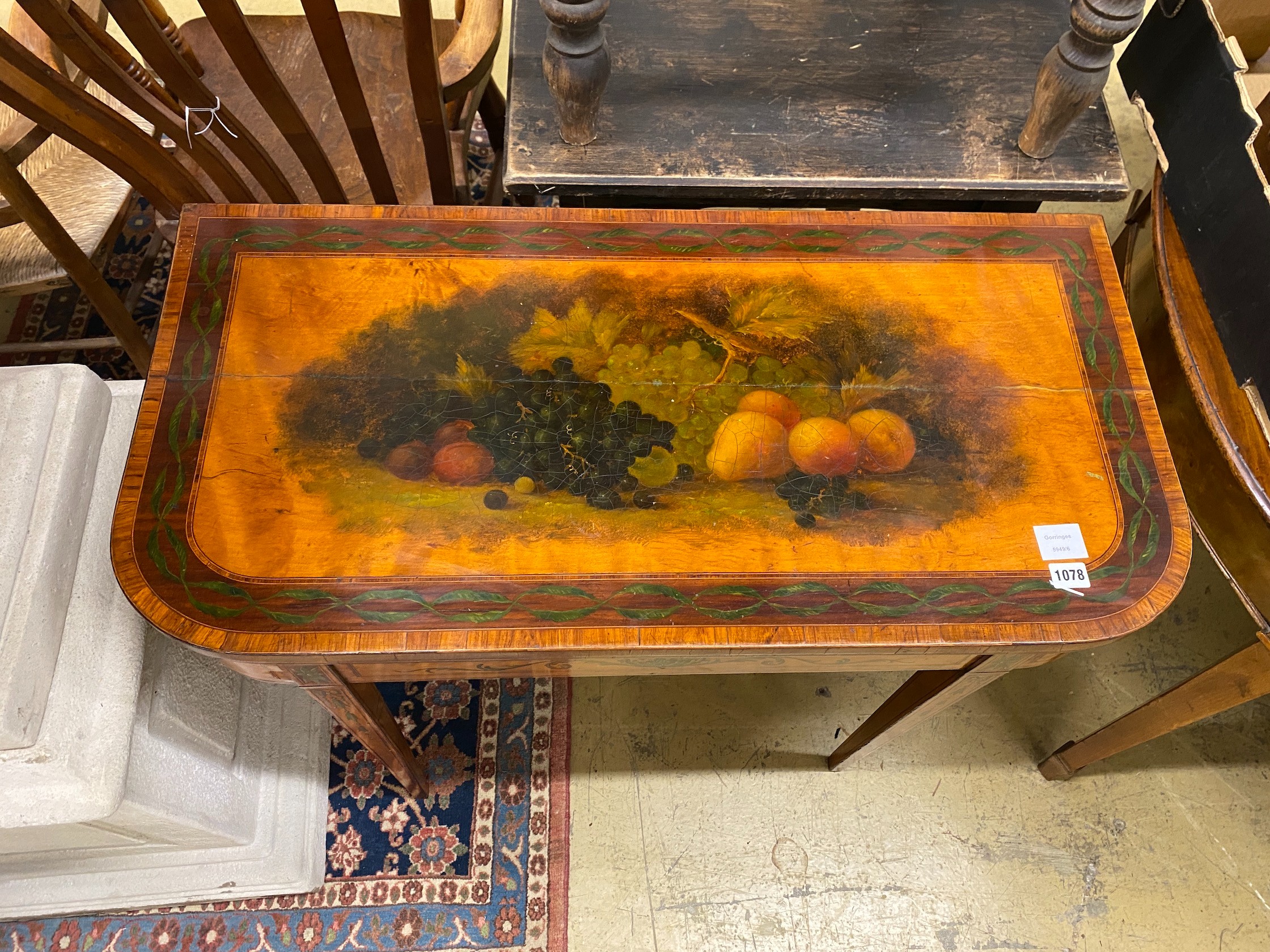 A George III banded satinwood folding card table with later painted decoration, width 92cm, depth 45cm, height 74cm